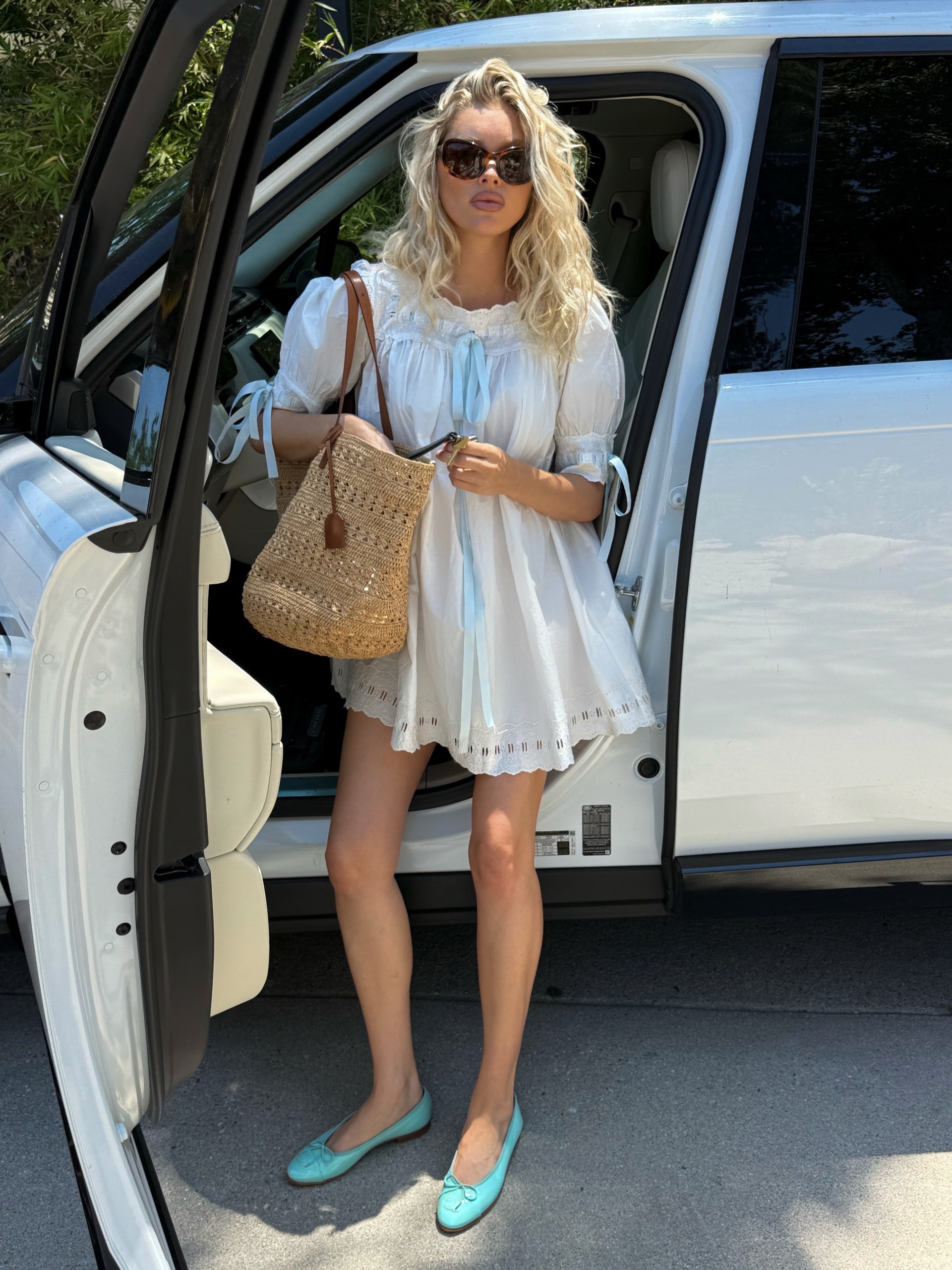 Woman in a babydoll dress and ballet flats.