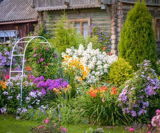 Densely planted flower garden in front of a house