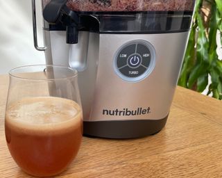 A glass of freshly-pressed apple juice and close-up of Nutribullet Pro appliance