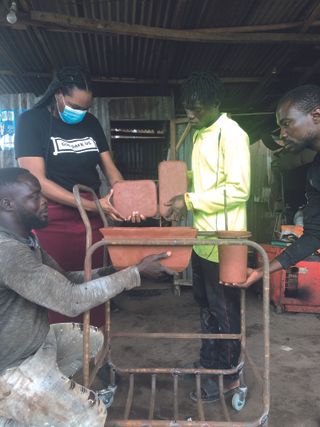 Artisans in Lagos assembling portable hand washing station.