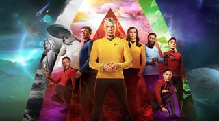 eight star trek characters stand in front of a spacey background featuring planets and streaking meteors.