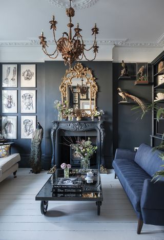 Gothic style living room with navy sofa and taxidermy