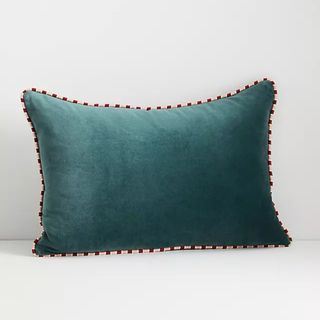 teal velvet pillow with red and white edge