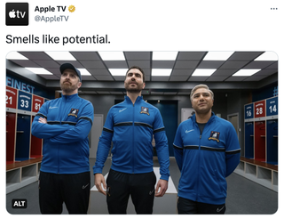 A tweet from @AppleTV that reads "Smells like potential" that shows Coach Beard (Brendan Hunt), Roy Kent (Brett Goldstein), and Nate (Nick Mohammed) stand in the locker room, wearing their new coaching uniforms, looking up at the Believe sign.