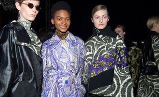 Models wear floral printed dress and patched coats and hexagonal sunglasses