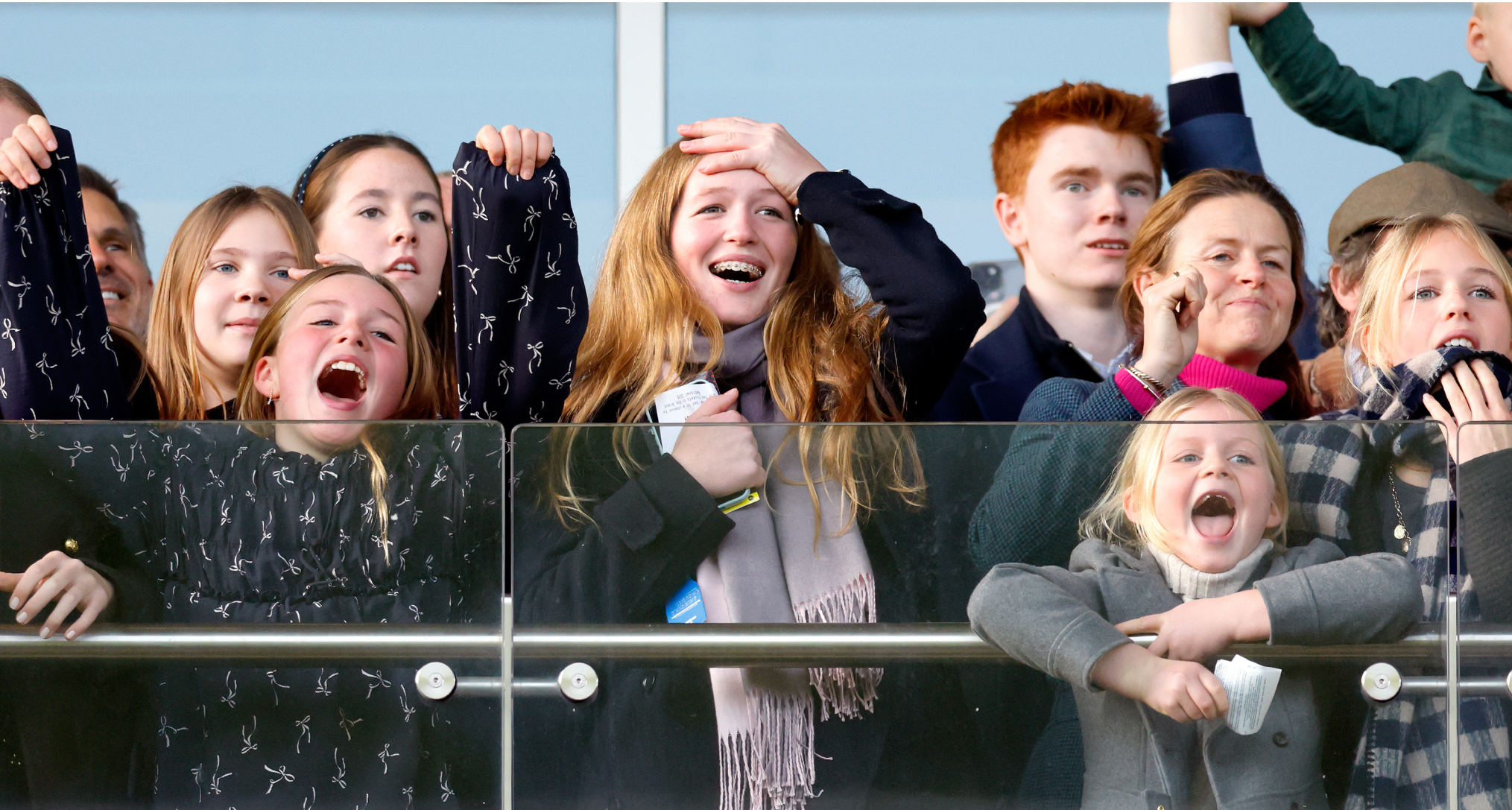 Mia and Lena Tindall cheering along a barrier with Savannah Phillips