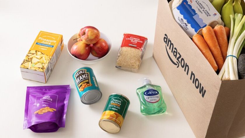 Amazon now brown paper bag with groceries beside it 