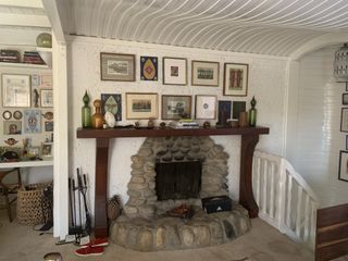 A dated fireplace with a dark wooden mantel