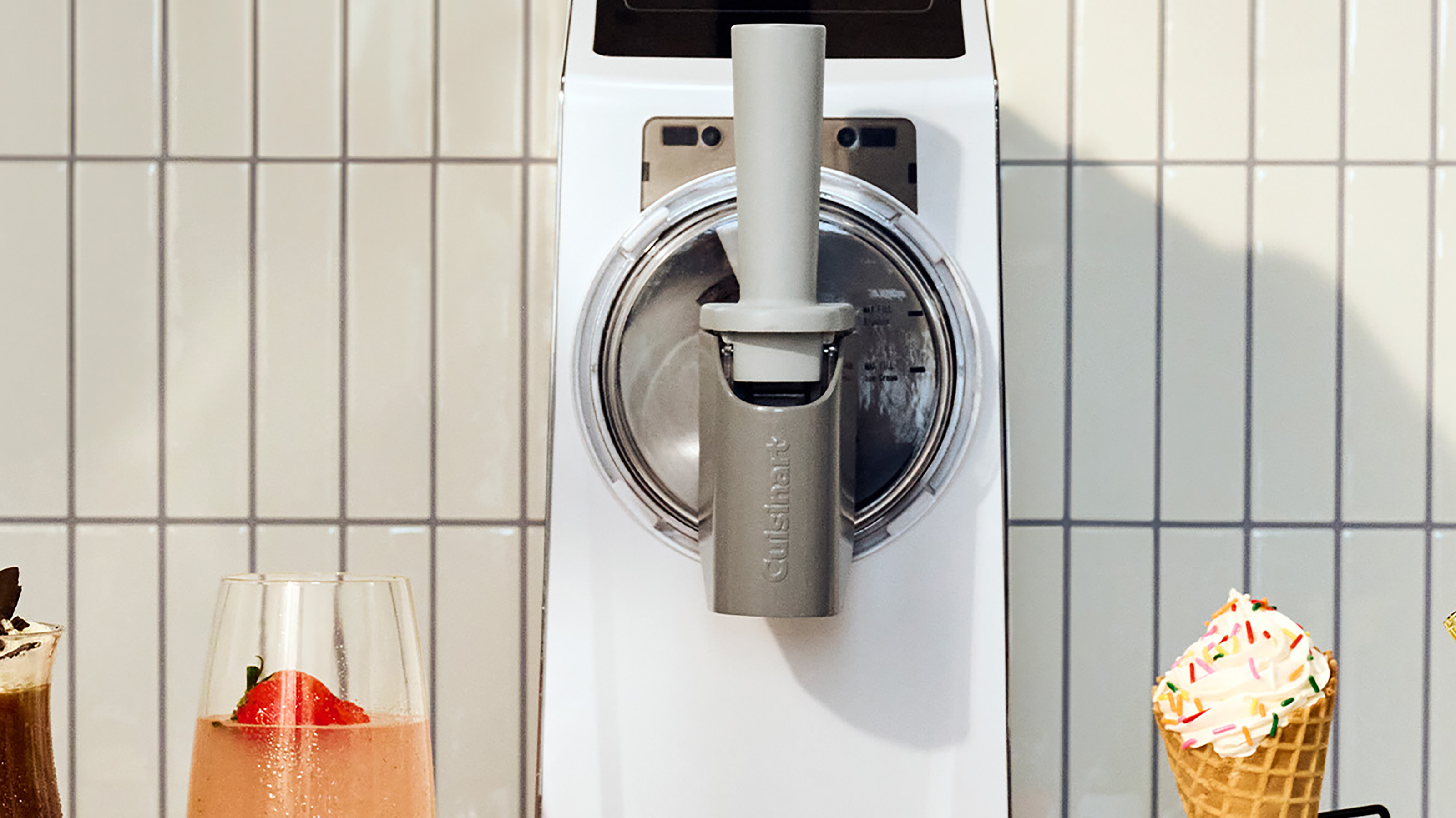 Cuisinart slushie and soft serve machine with various drinks and ice creams around it in a promotional image