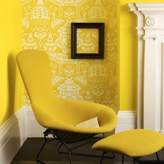 primary yellow chair against patterned wall