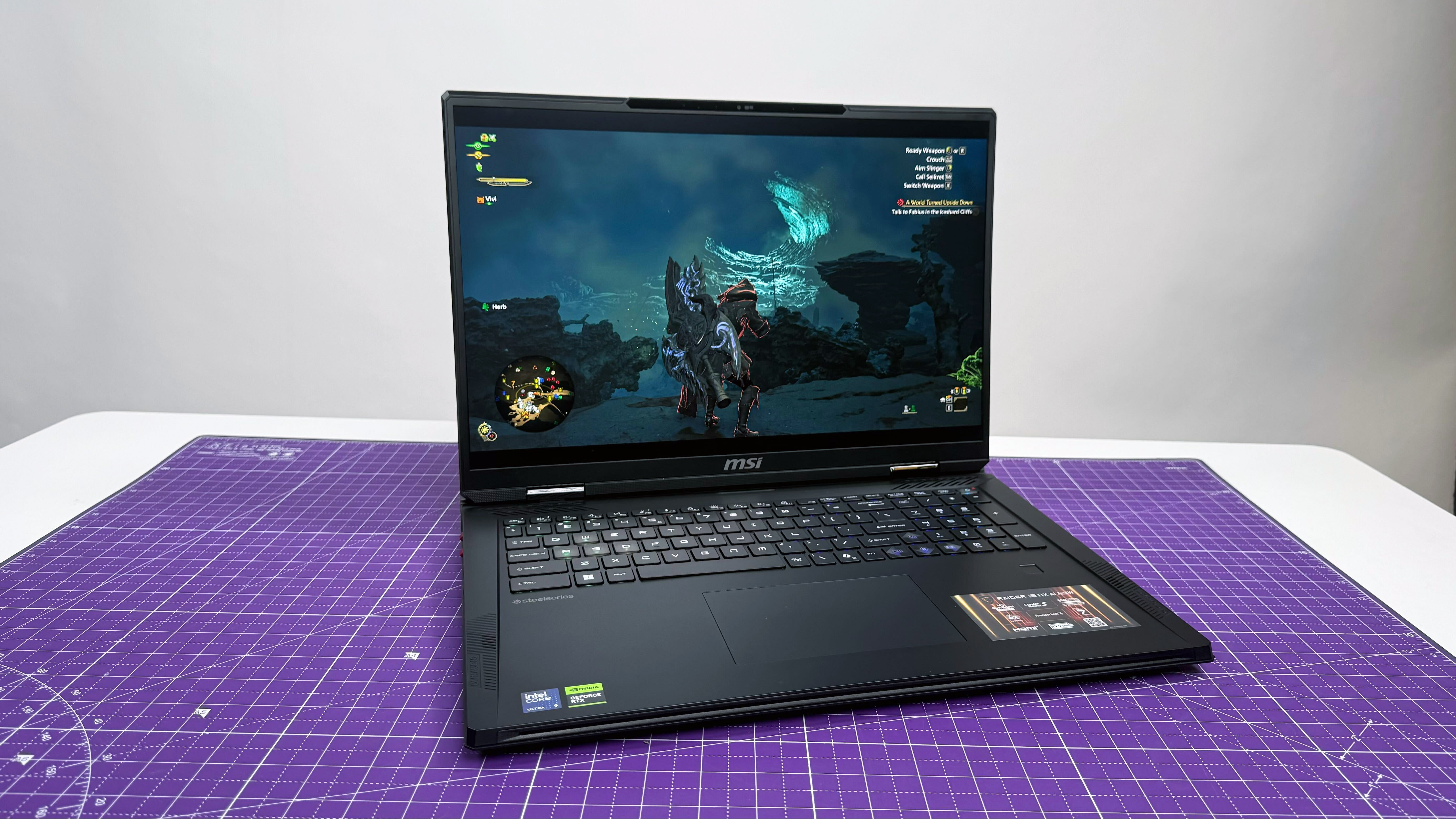 MSI Raider 18 HX AI gaming laptop open facing on a purple mat against a gray background.