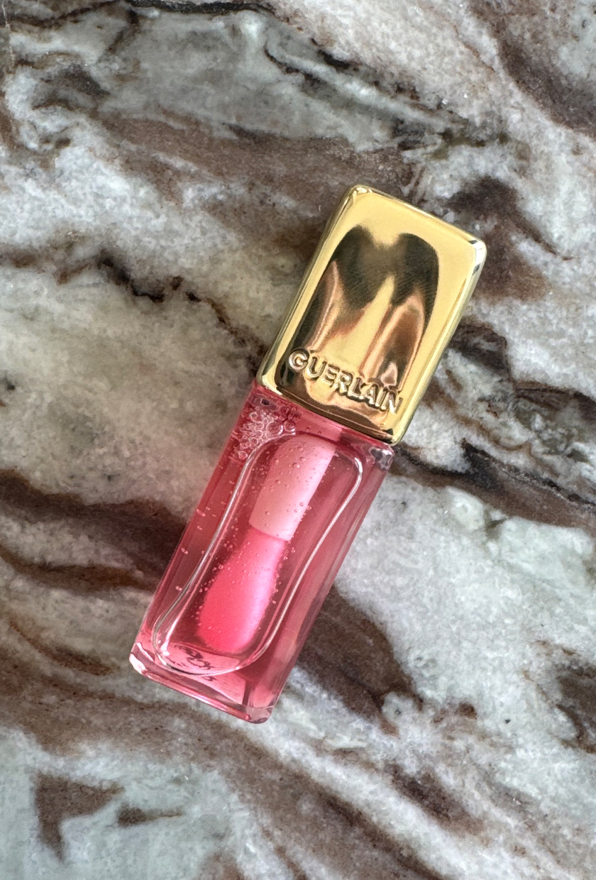 guerlain lip oil on marble table