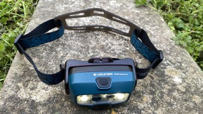 LedLenser HF8R Signature Headlamp on a rock
