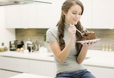 Woman eating cake (LL)