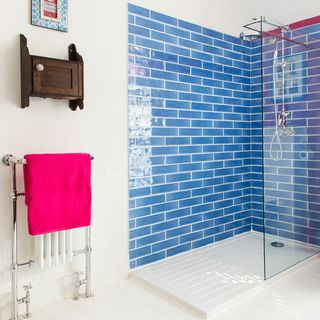bathroom with blue tiled shower