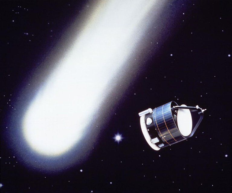 A cylindrical spacecraft flying near a white comet against a starfield.