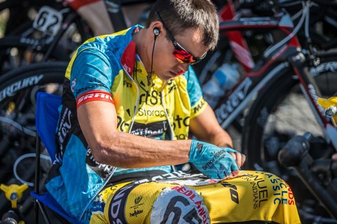 Travis McCabe (Smart Stop) pins up the yellow jersey.