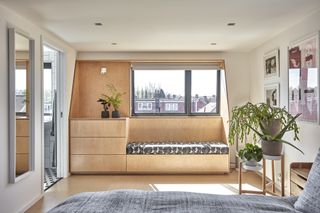 Loft bedroom with built-in plywood furniture
