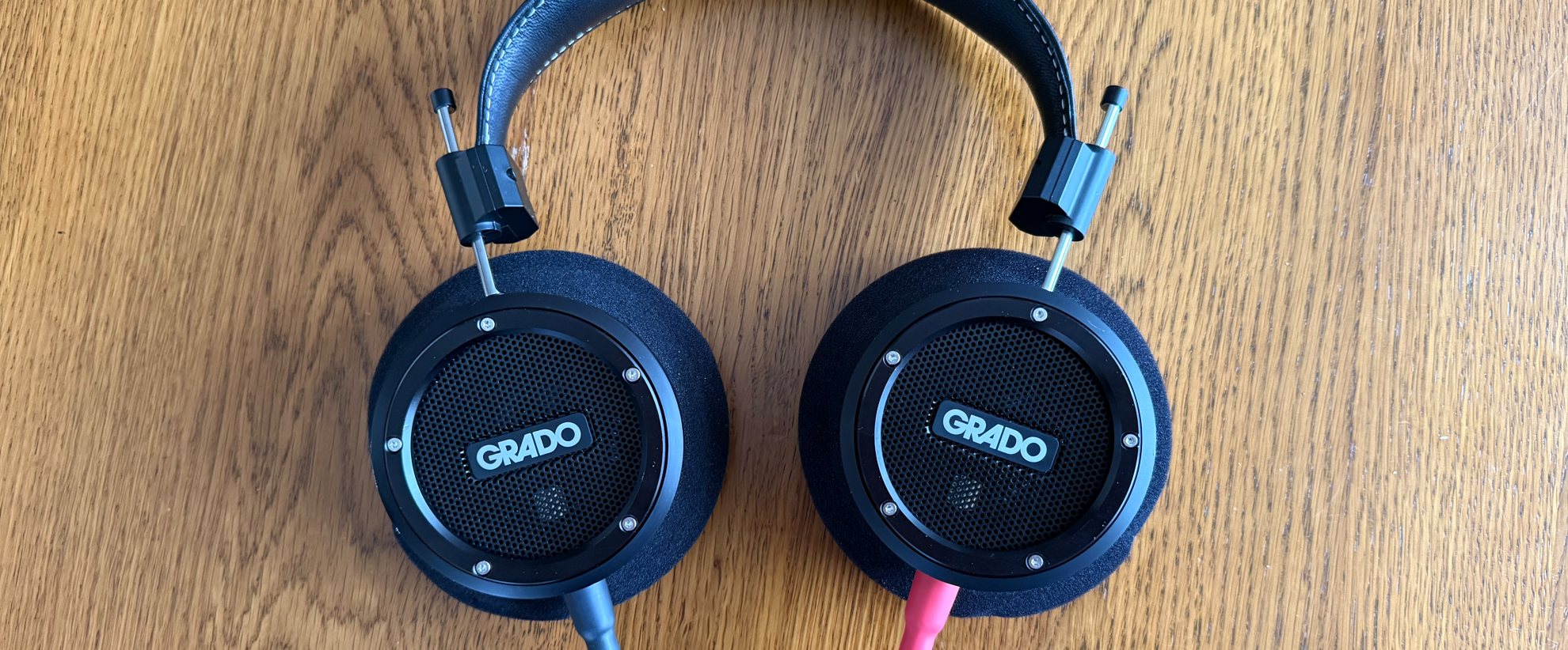 Grado Signature S750 headphones shot from above, sitting on a wooden table