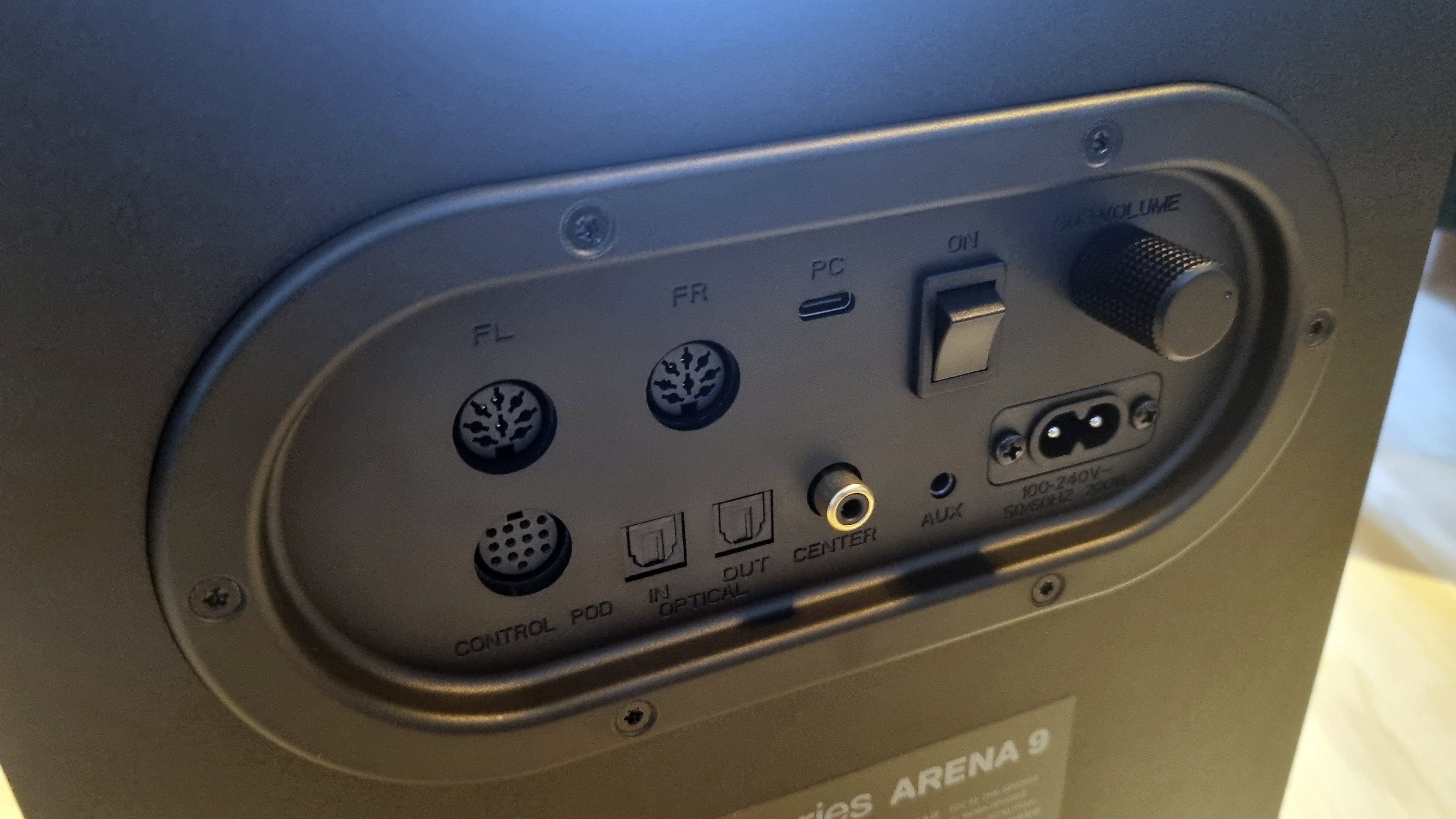The rear connector pane of the SteelSeries Arena 9 subwoofer, showing the various inputs and outputs along with power switches and subwoofer volume control