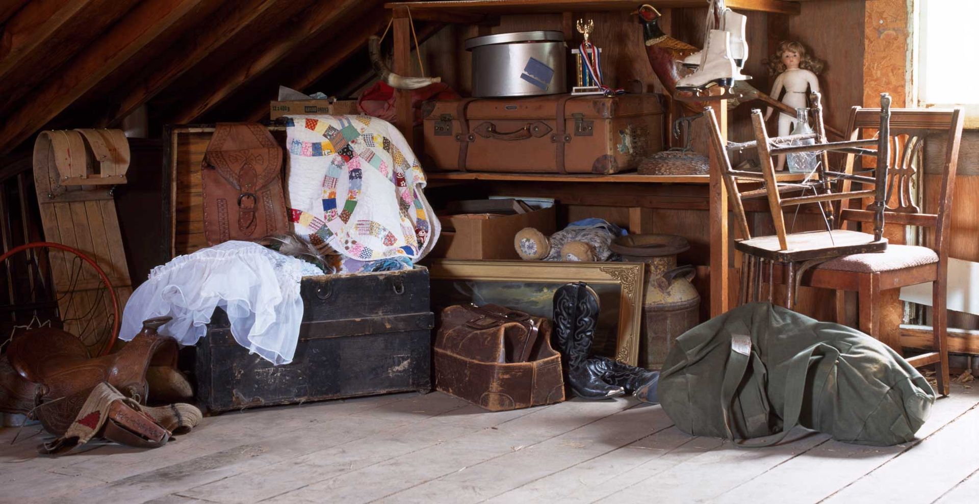 loft filled with boxes and piles of clutter in need of professional solutions to tackle how to declutter your loft