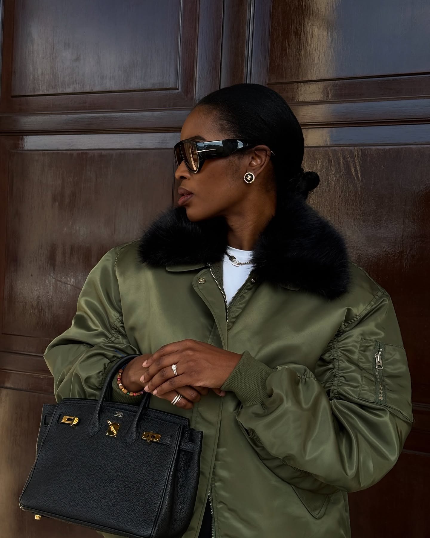 Influencer @nlmarilyn wears a khaki satin bomber jacket.