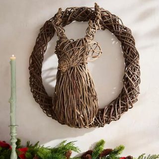 Vine Reindeer Wreath against a white wall.