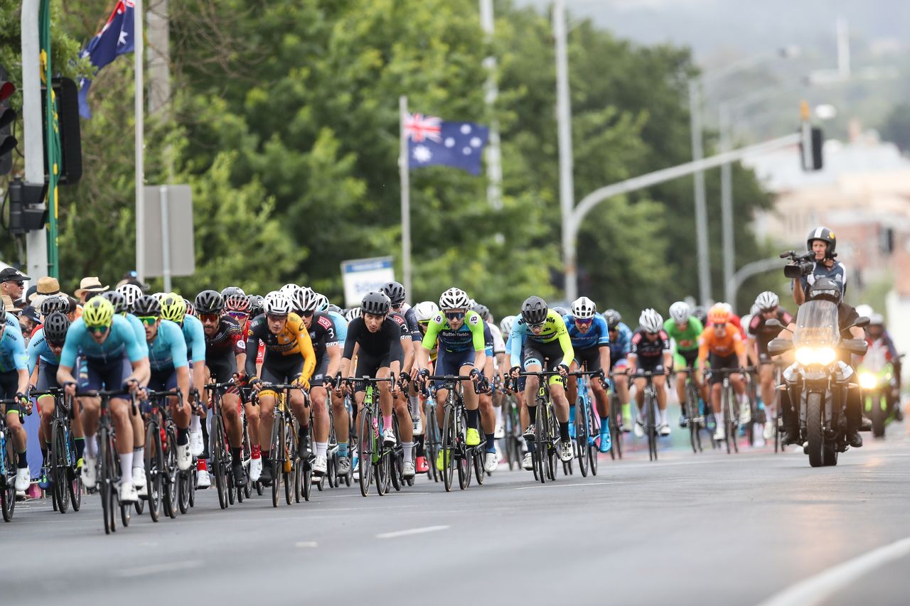 A camera bike watches on during the race
