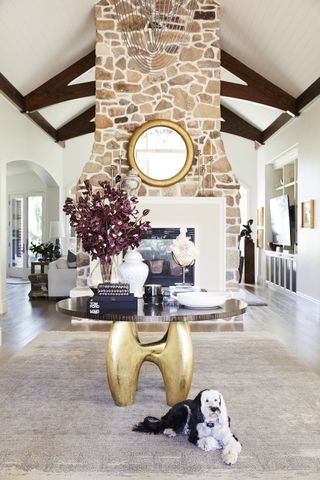 Farmhouse living room with exposed stone and a mirror