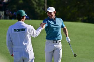 Rory McIlroy high fives his caddie at The Masters