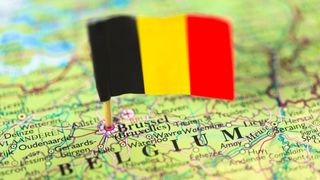 Close-up of a map of Belgium with a Belgian flag pinned at Brussels.