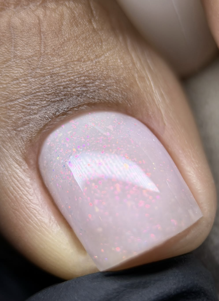 a big toe with sparkly pink polish