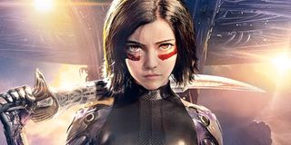 Alita: Battle Angel Alita stands with the Damascus Blade with Zalem in the background.