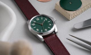green-dial watch with brown leather strap