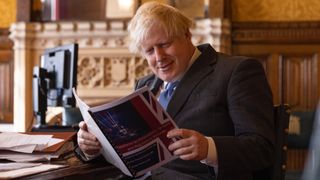 Boris Johnson reading the report prepared by a special taskforce of Conservative MPs