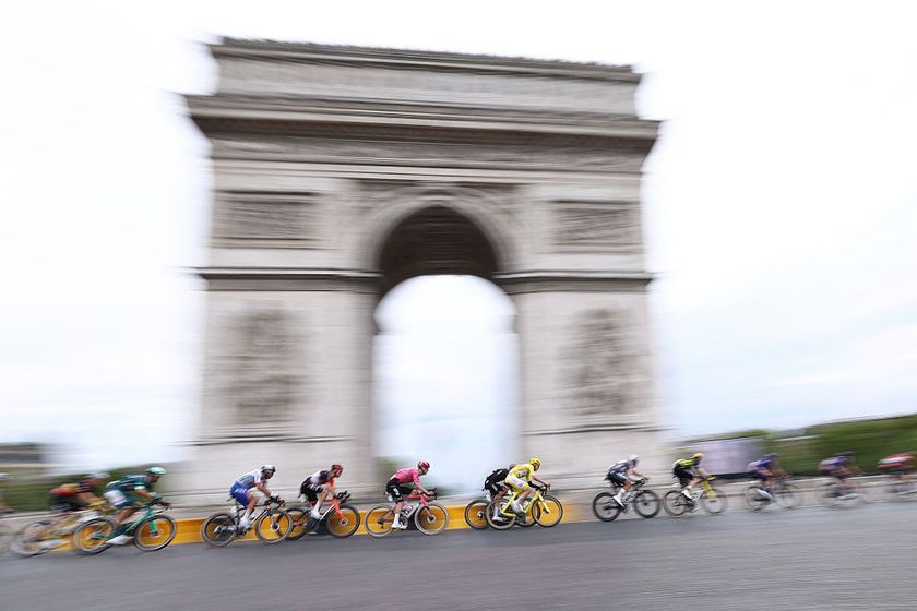 UAE Team Emirates - XRG team's Slovenian rider Tadej Pogacar wearing the overall leader's yellow jersey cycles with the pack of riders (peloton) past the Arc de Triomphe on Place Charles de Gaulle during the 21st and final stage of the 112th edition of the Tour de France cycling race, 132.3 km between Mantes-la-Ville and Paris' Champs-Elysees Avenue, on July 27, 2025. (Photo by Anne-Christine POUJOULAT / AFP)