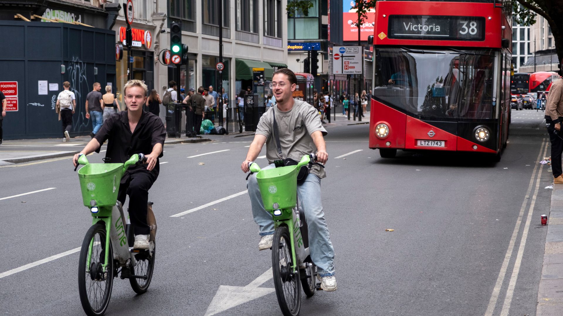 Two young men riding Lime electric bicycles on 3rd August 2025 in London, United Kingdom. A bicycle-sharing system or bike share program, is a shared transport service where bicycles are available for shared use by individuals for a fee. The programmes themselves include both docking and dockless systems. (photo by Mike Kemp/In Pictures via Getty Images)