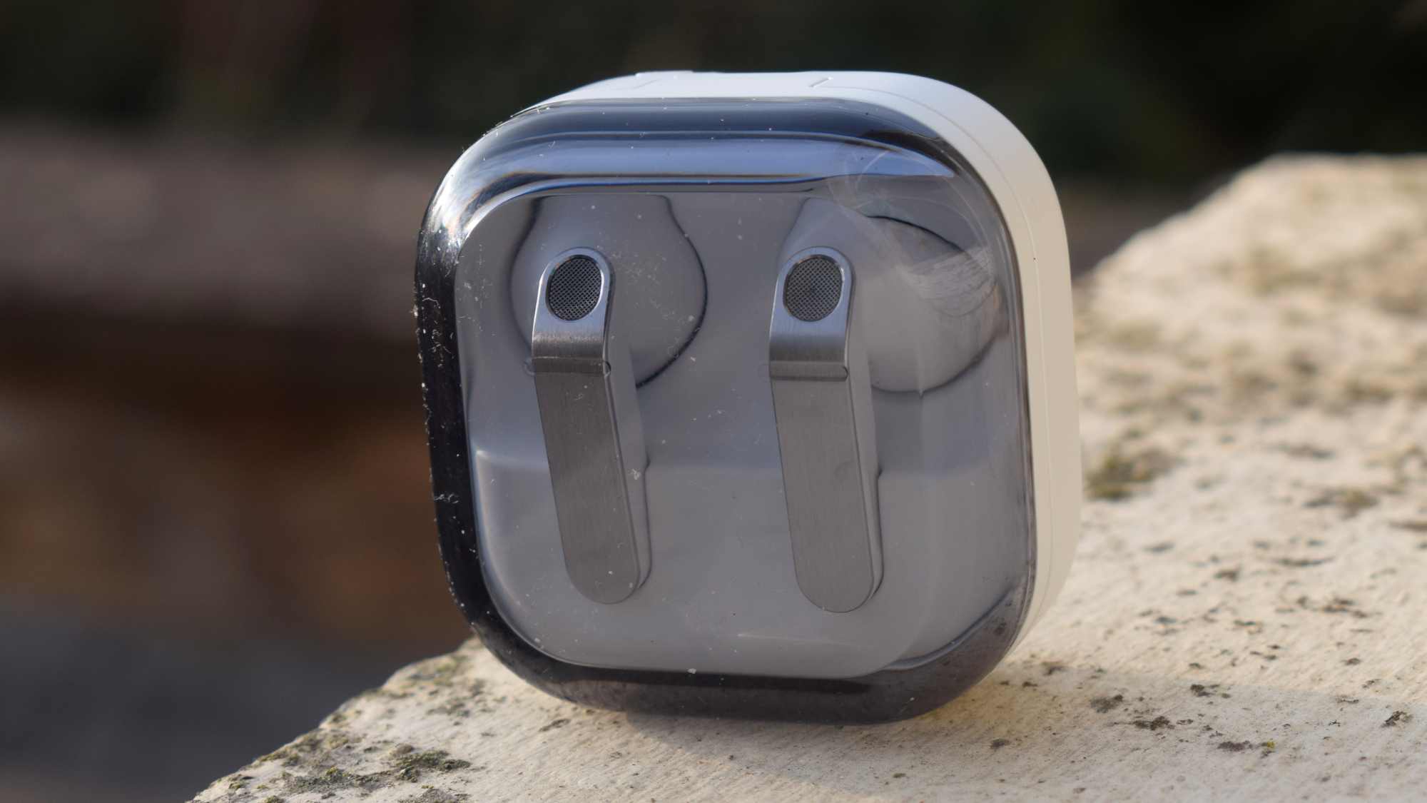 The Samsung Galaxy Buds 4 earbuds in their case on a ledge.