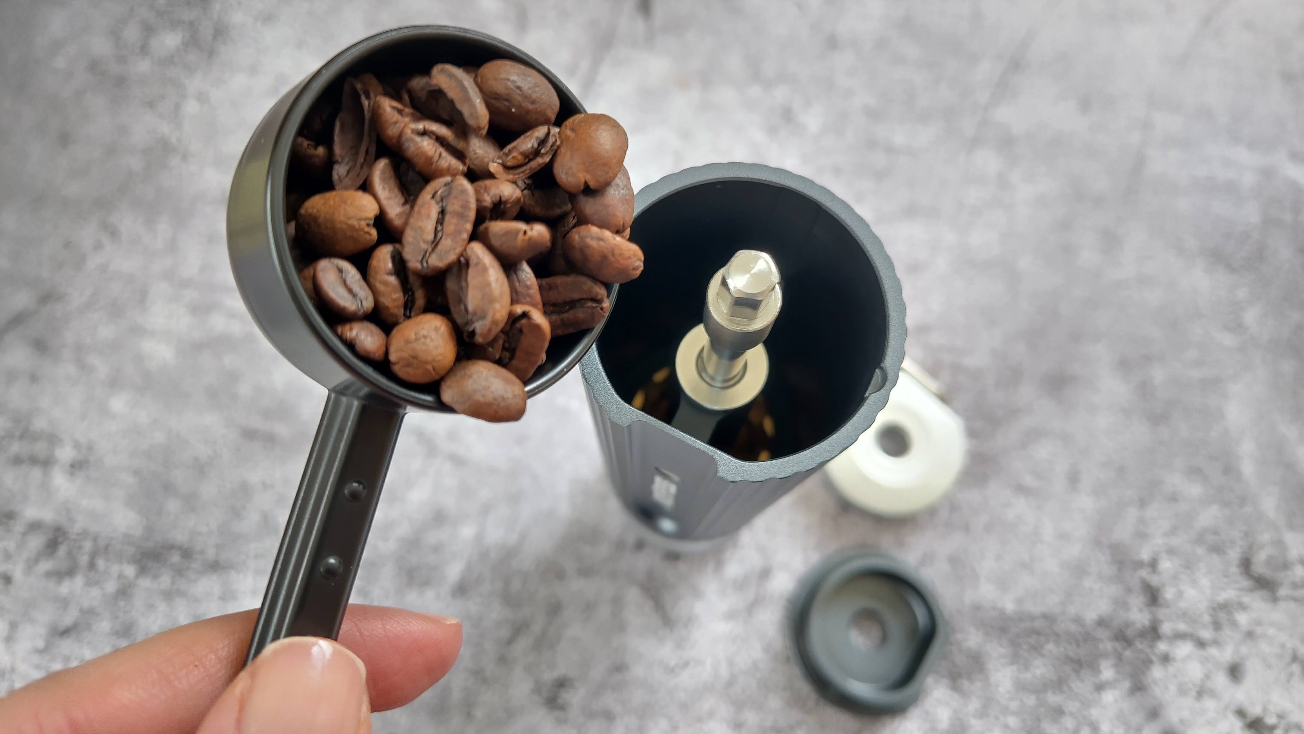 Adding coffee beans to Aeropress manual coffee grinder