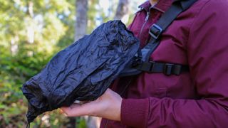 Cotton Carrier Skout G2 worn by a man in a burgandy jacket outdoors in a woods