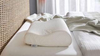 Tempur-Neck Pillow on a bed