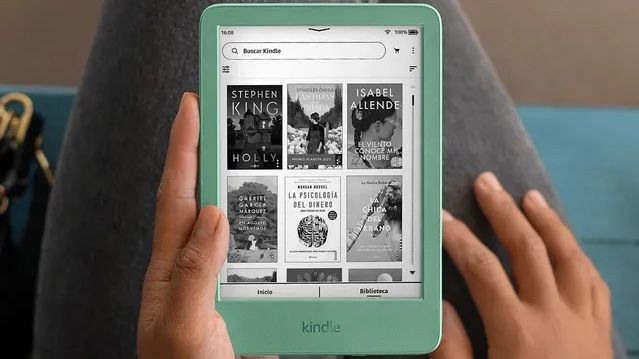 A person holding the Matcha Green Amazon Kindle (2024 release)