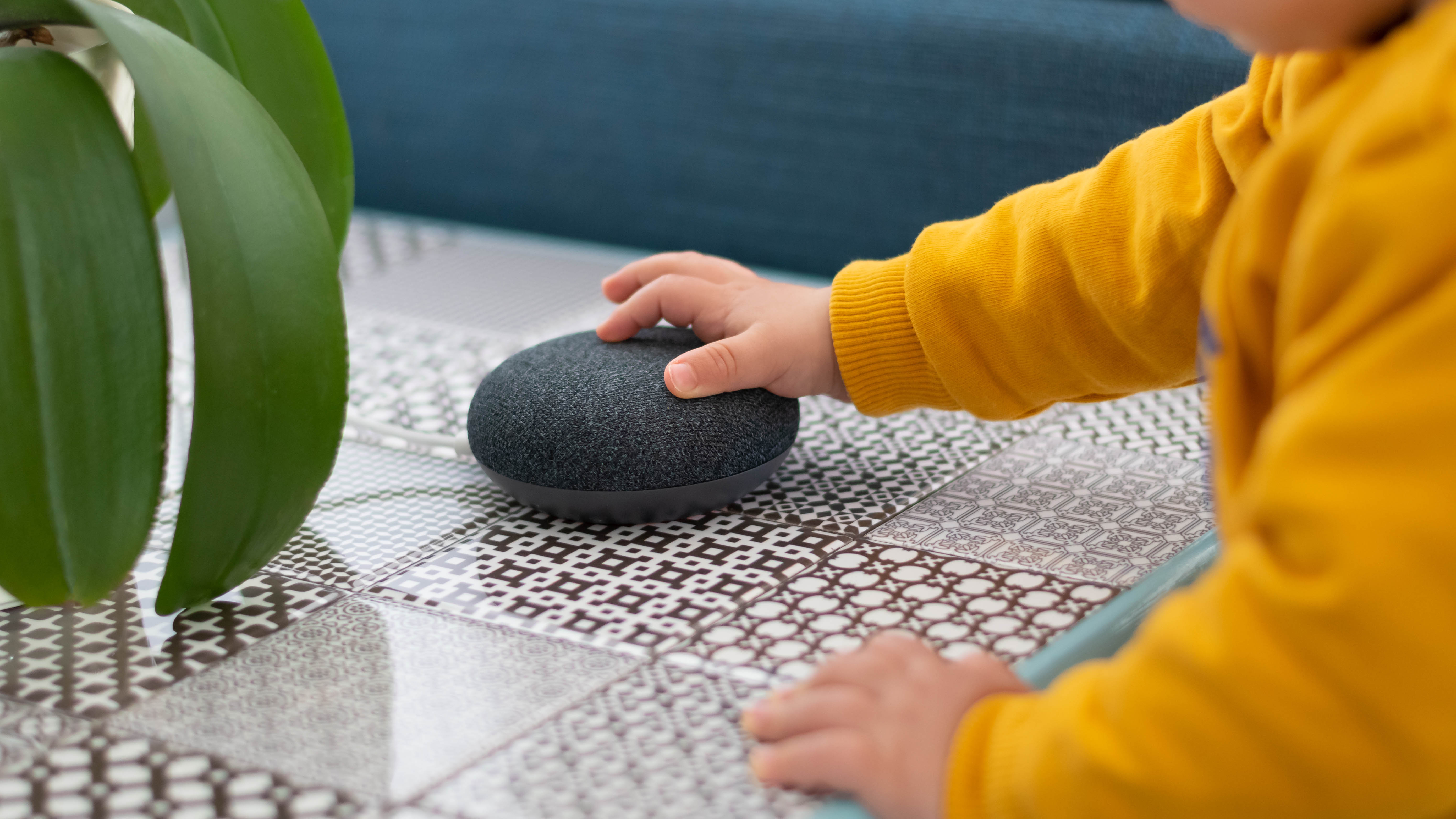 A child touching a smart home assistant