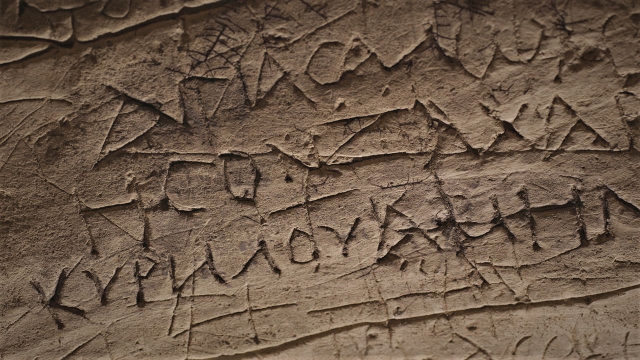 Salome&rsquo;s cave wall with old Greek writing inscribed onto it by Christian pilgrims.