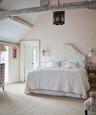 calming bedroom with pale pink color scheme and neutral carpet