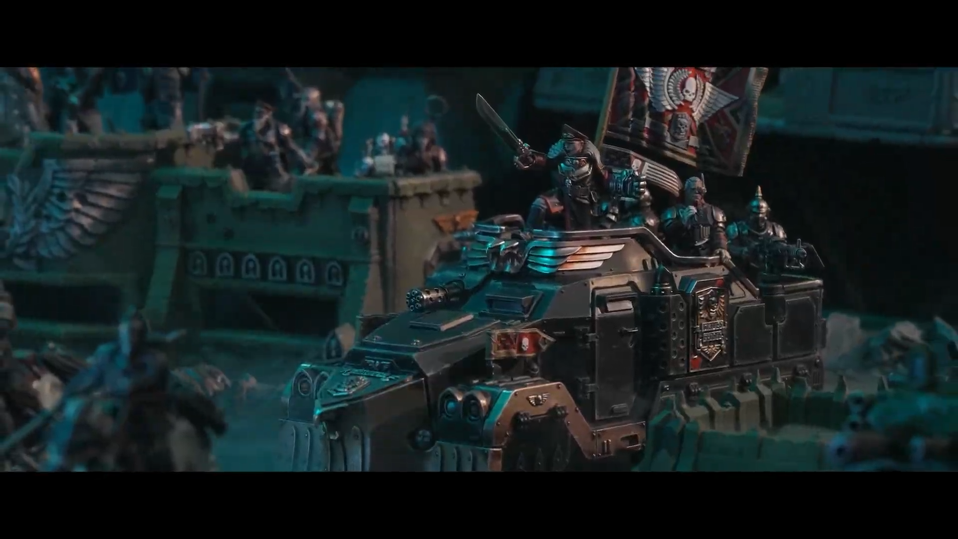 Warhammer miniatures posed against terrain and other models