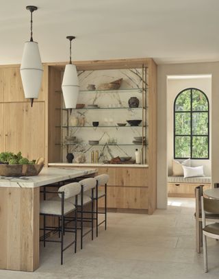 A kitchen with wood island, storage and ceramic floor tiles