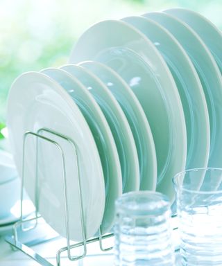 An image of a plate rack with white plates