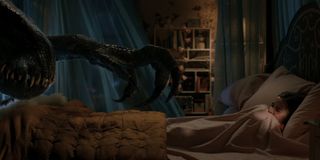 The Indoraptor reaches towards a frightened Isabella Sermon in Jurassic World: Fallen Kingdom.