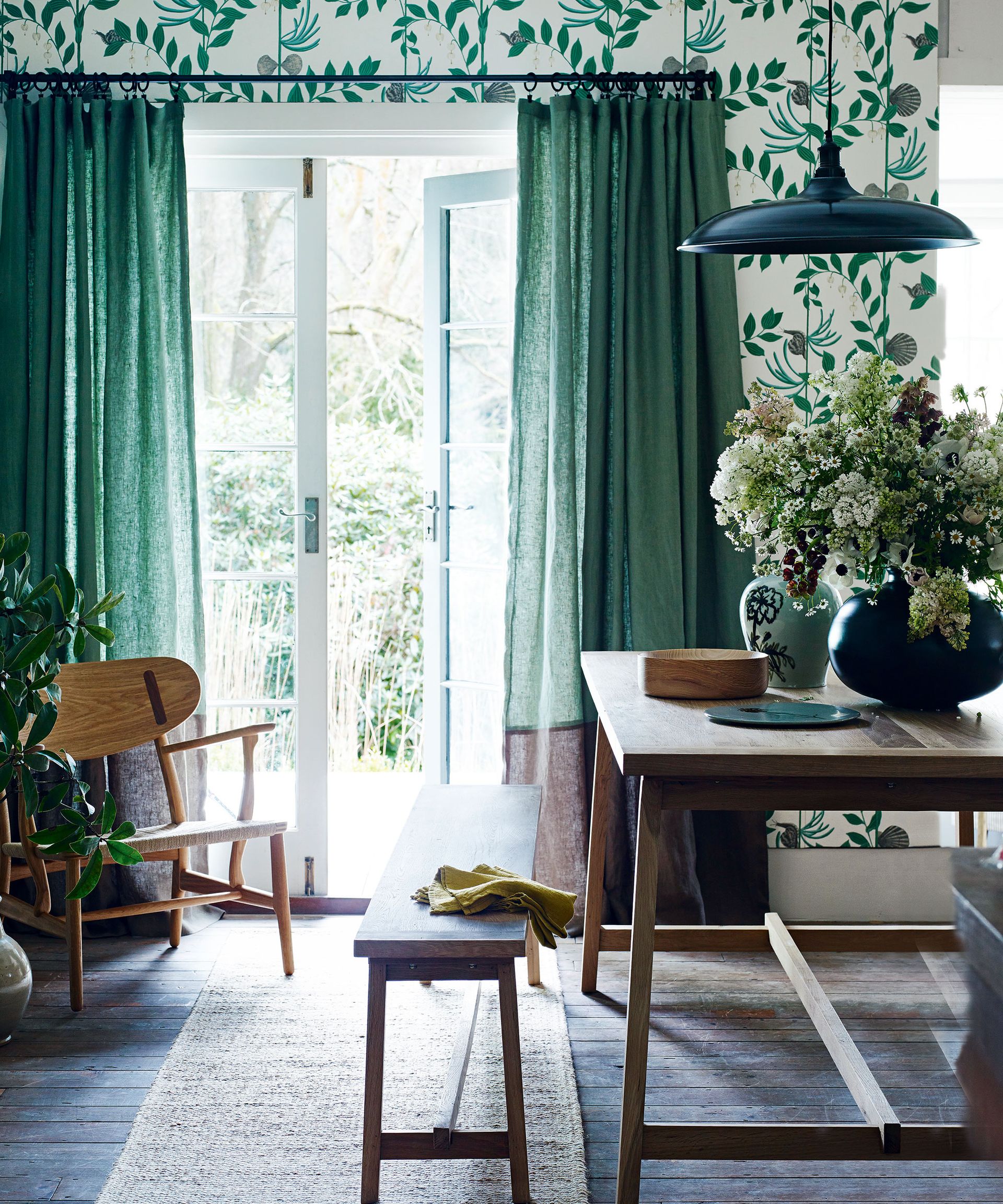 Green dining room ideas with wooden table and patterned wallpaper